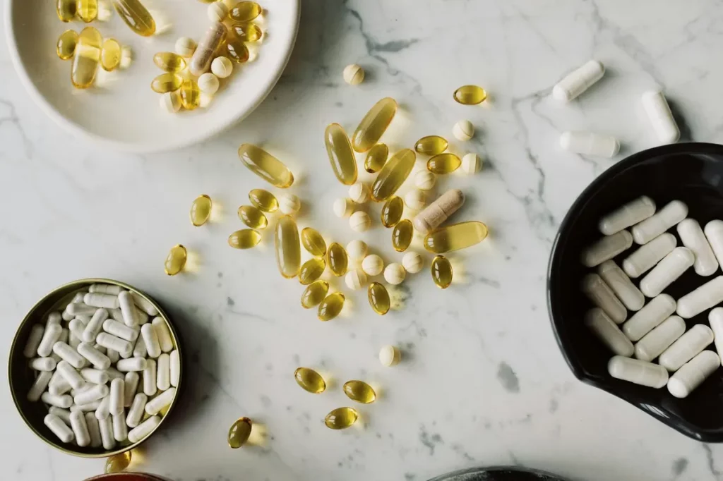 A bright and vibrant arrangement of vitamin capsules and supplement bottles representing optimal health and wellness at Medikompetg